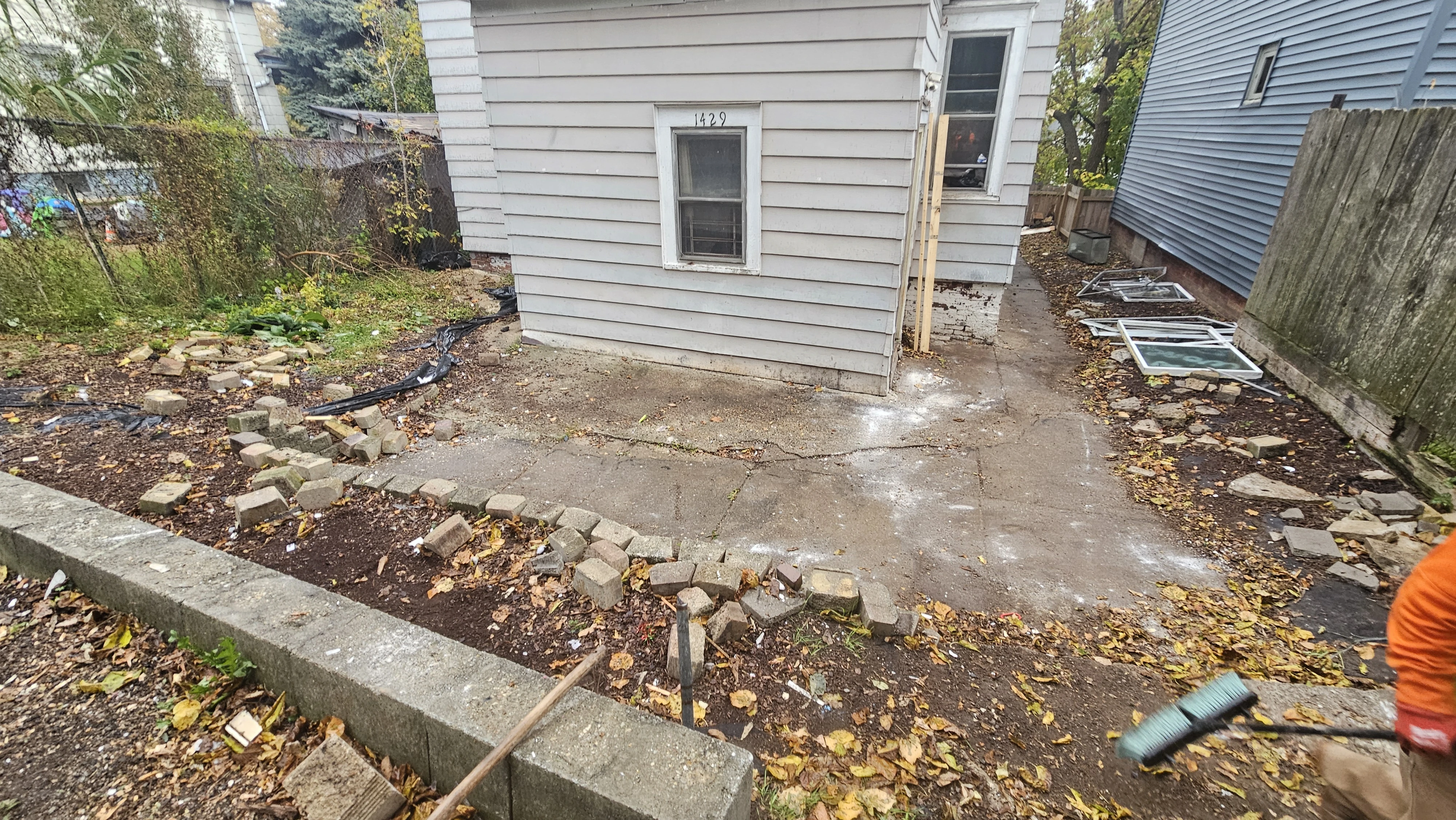 After the Milwaukee outdoor cleanout: main debris pile gone and pavement visible