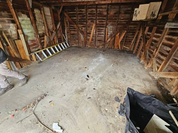 More concrete floor visible after the pile was removed from the same Milwaukee garage